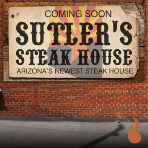 Sutler's Steak House Arizona horizontal banner on brick wall